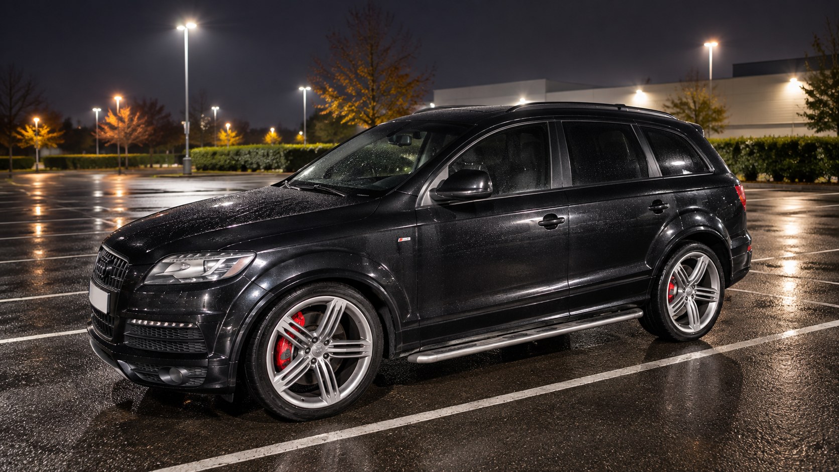 Abandoned SUV in a commercial parking area at night