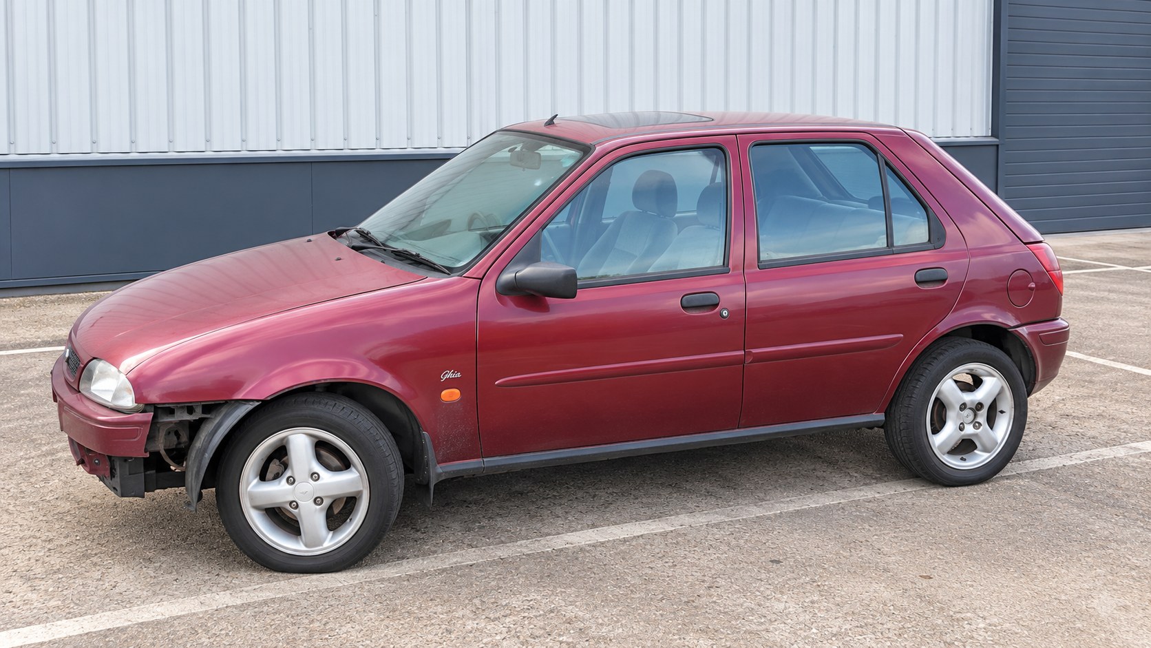 Unclaimed hatchback on industrial commercial land